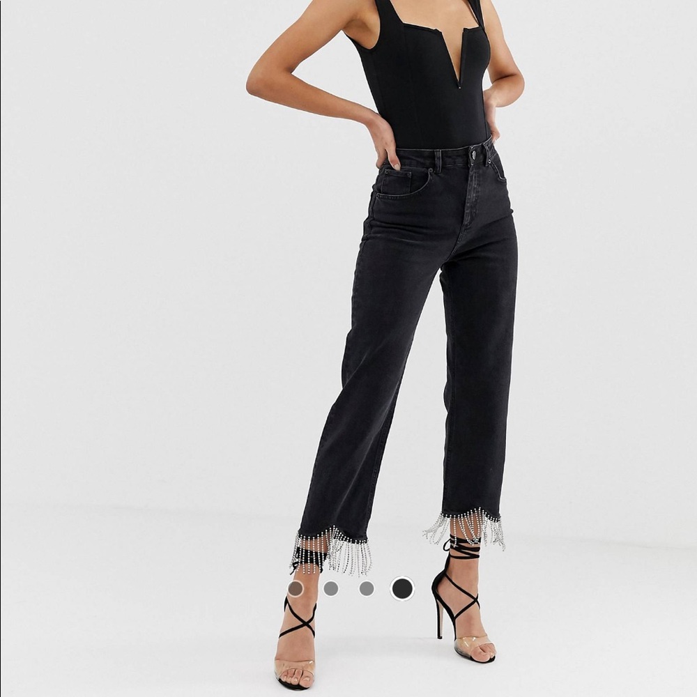 high waisted straight leg
jeans in washed black with rhinestone tassel hem